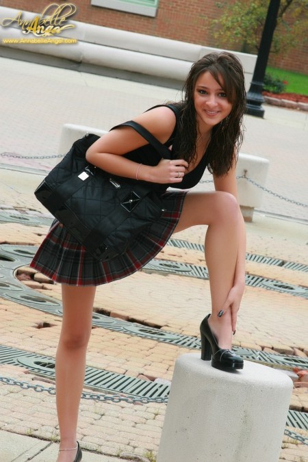 In a black t-shirt and a plaid skirt
