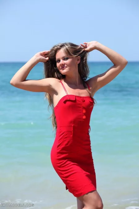 In a red dress on the beach